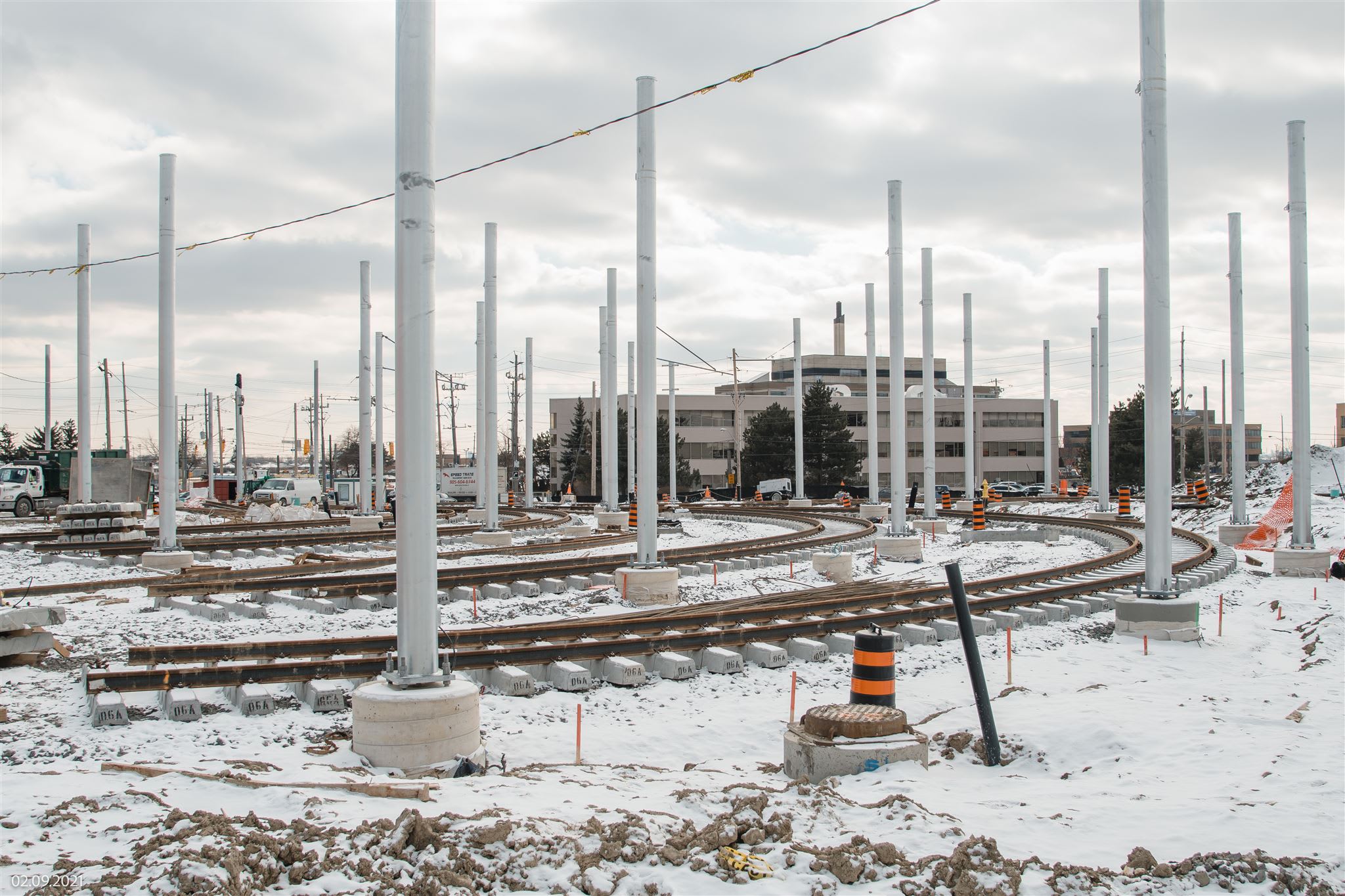Track installation at ground level outside the Finch West LRT maintenance and storage facility.