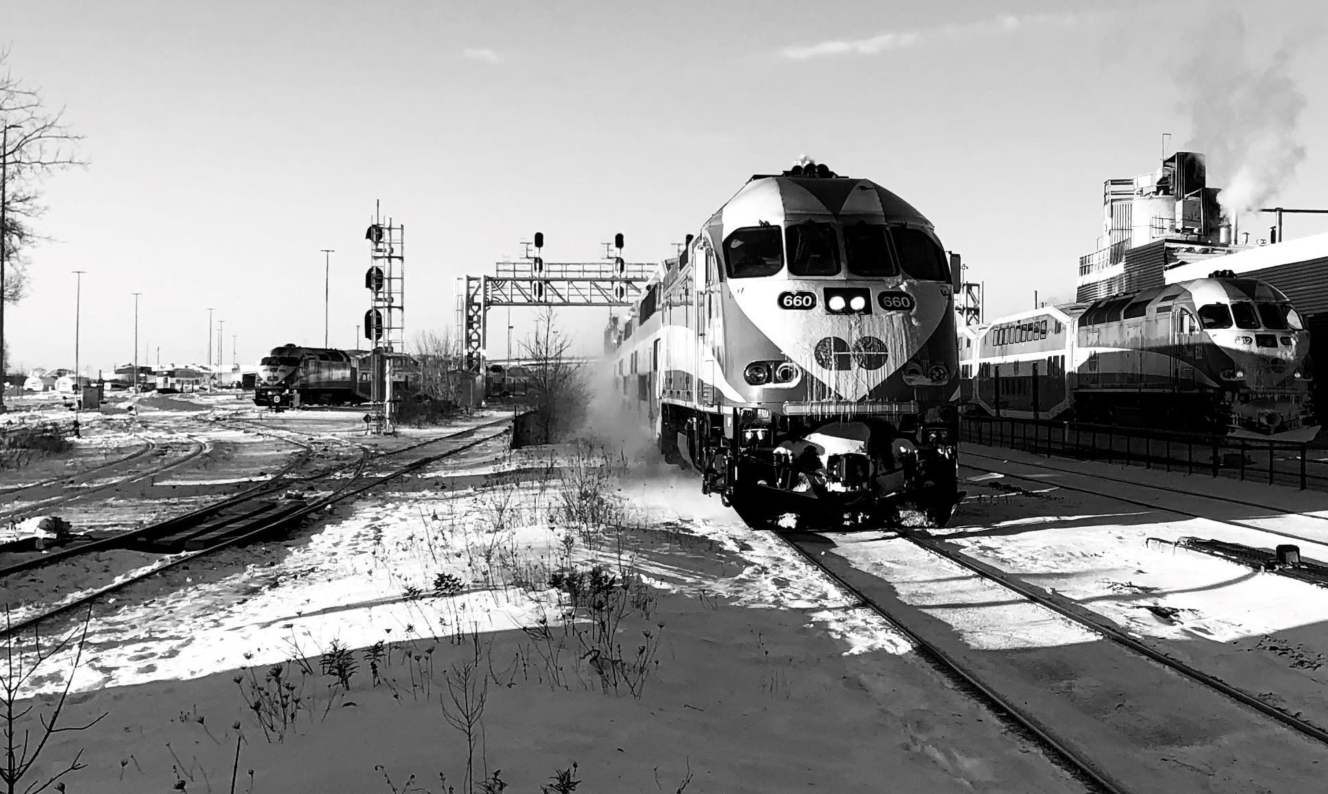 Two GO trains are seen on tracks.