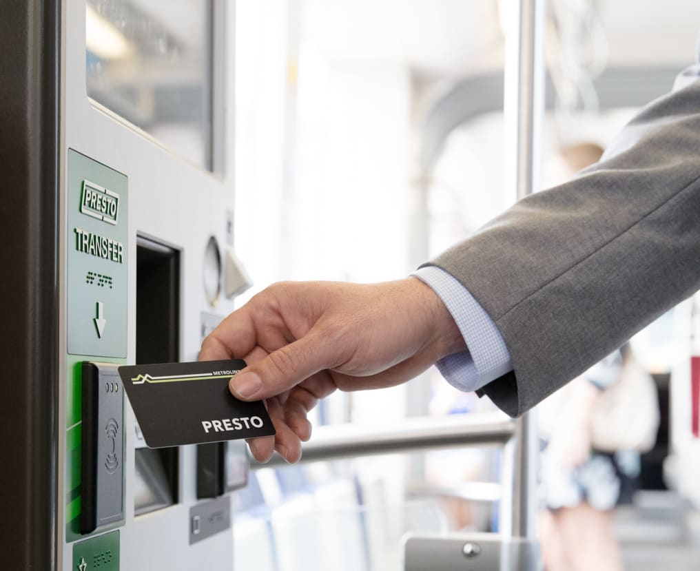 A man taps a PRESTO card.