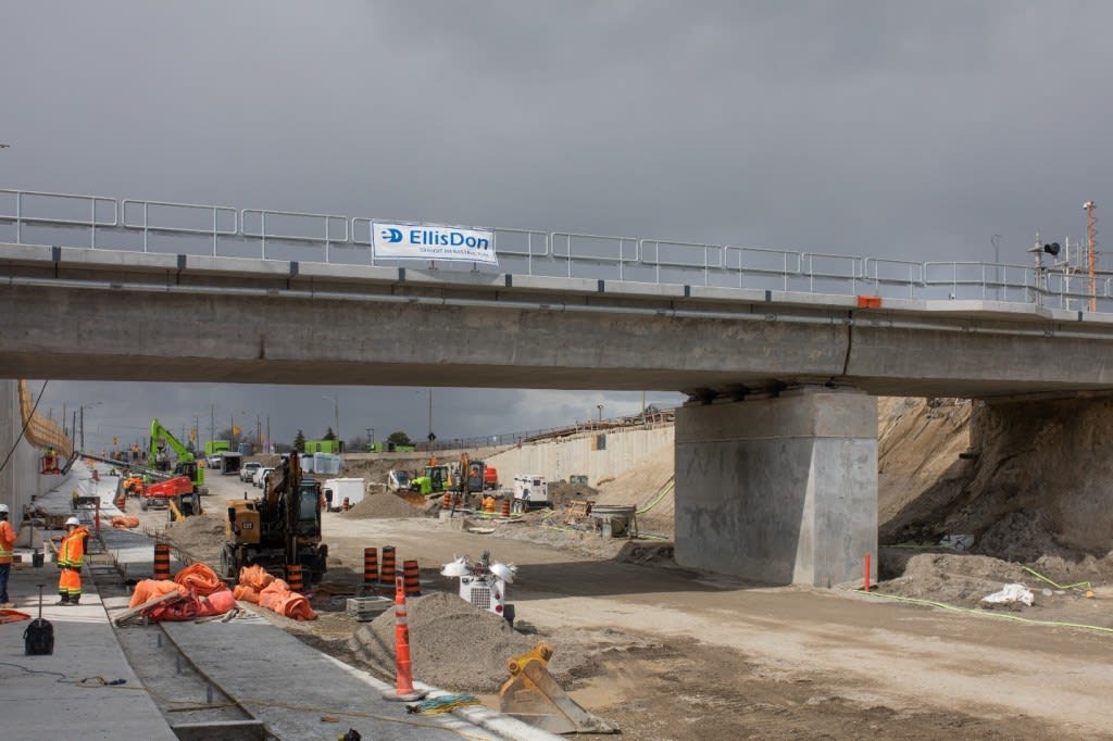 workers under a bridge.