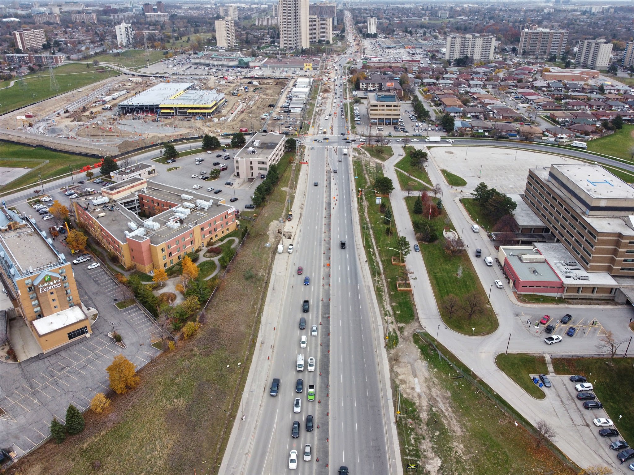 A construction site is shown next to a busy street.