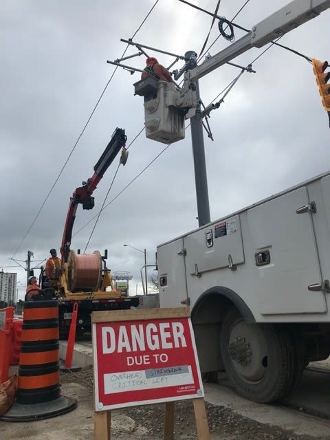 crews working on electrical poles.