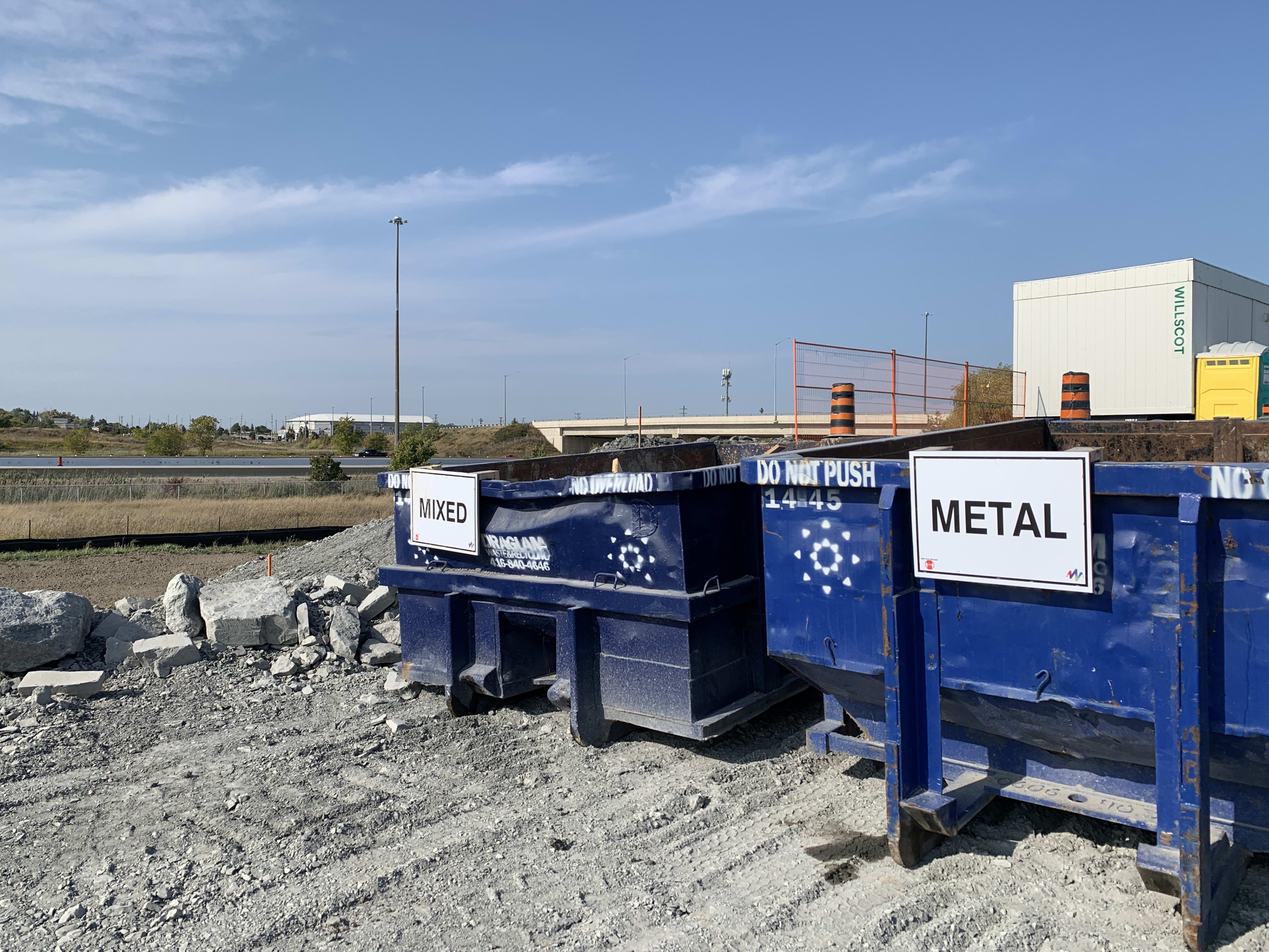 Two bins sits next to one another - one for mixed debris and one for metal.