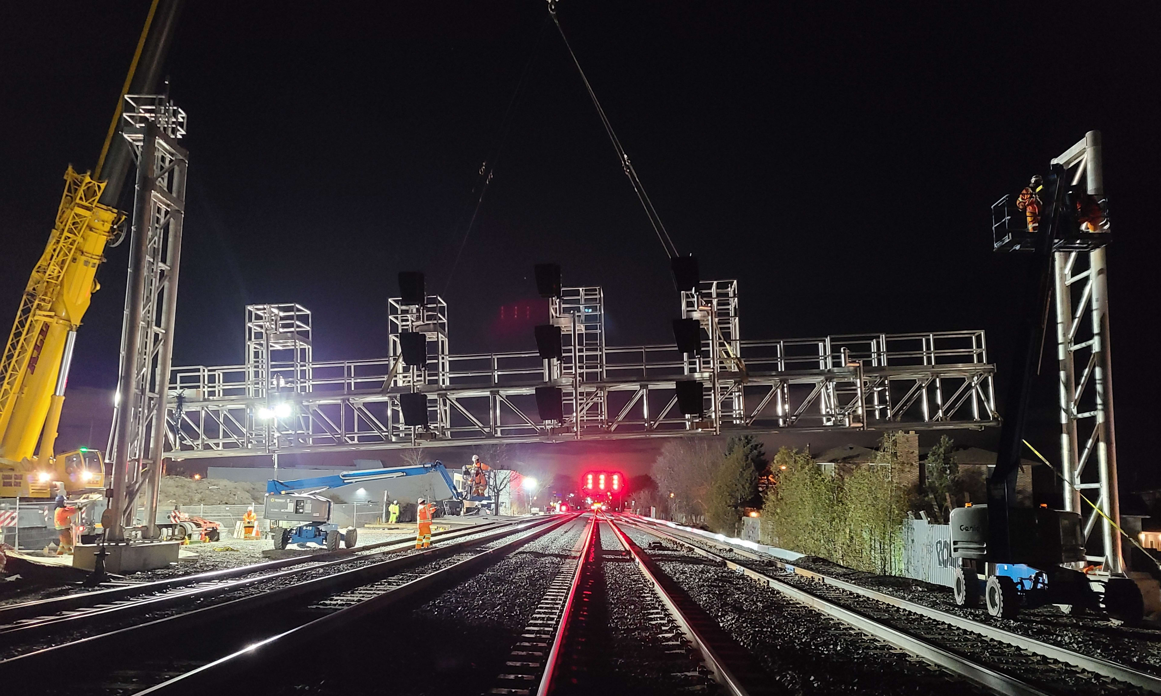 A new signal bridge is installed over the tracks