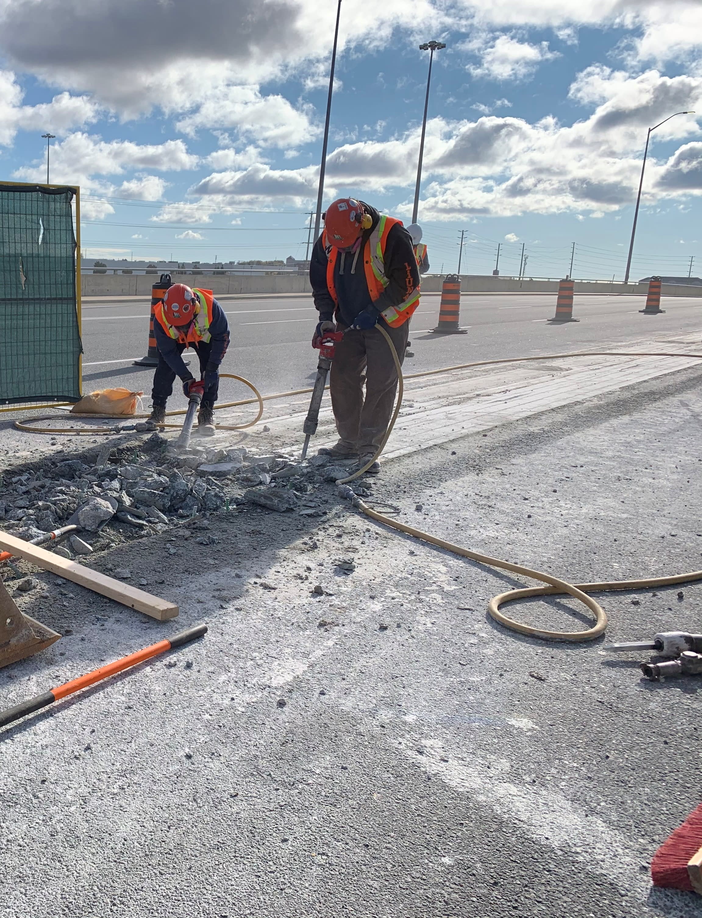 Crews use machines to chip concrete.