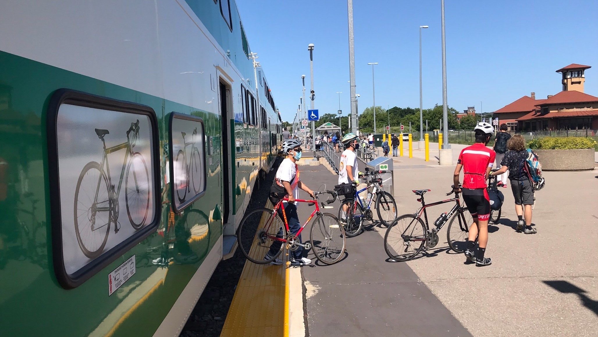 Customers exit a train with bikes