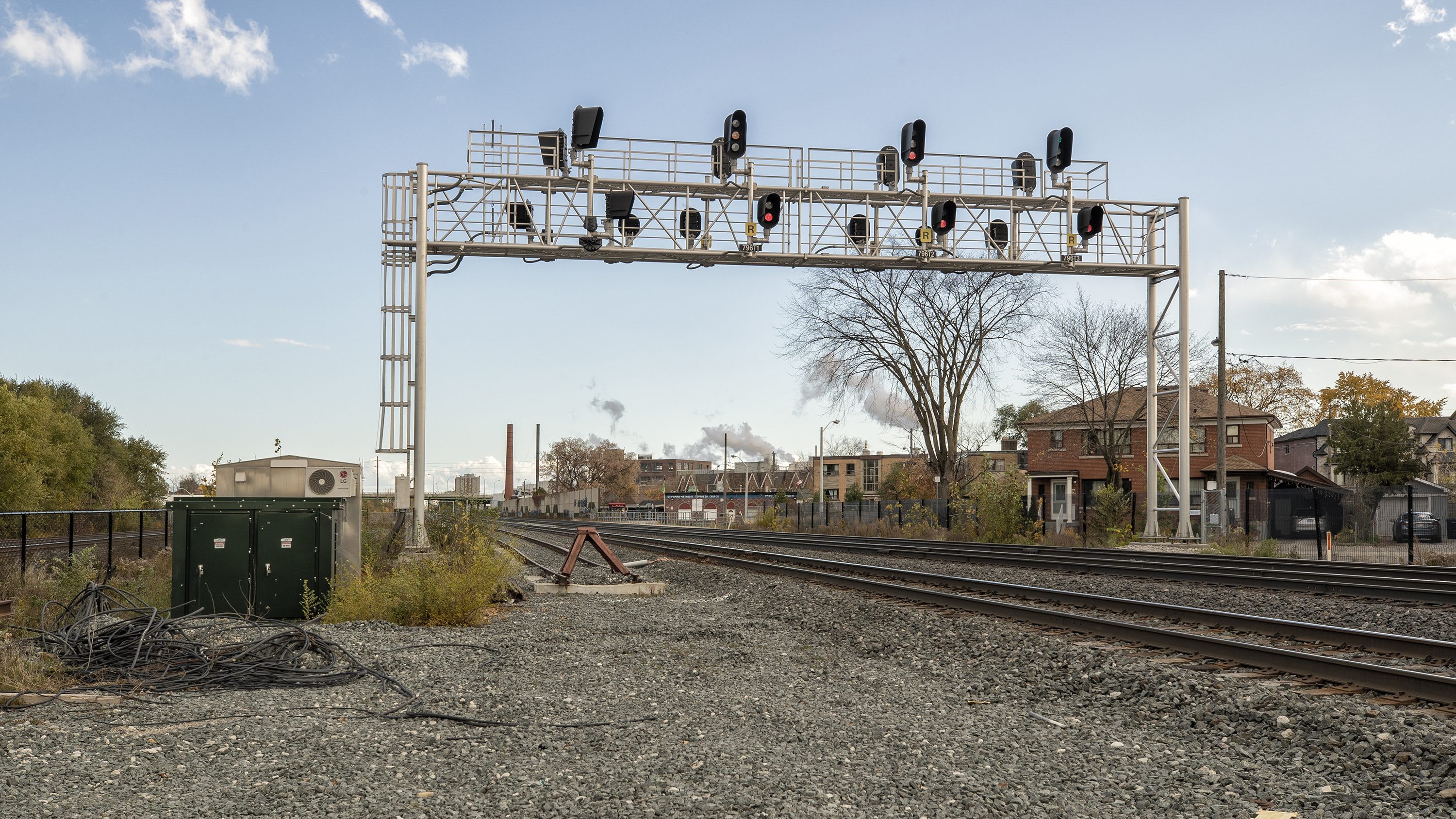 train tracks with signal bridge