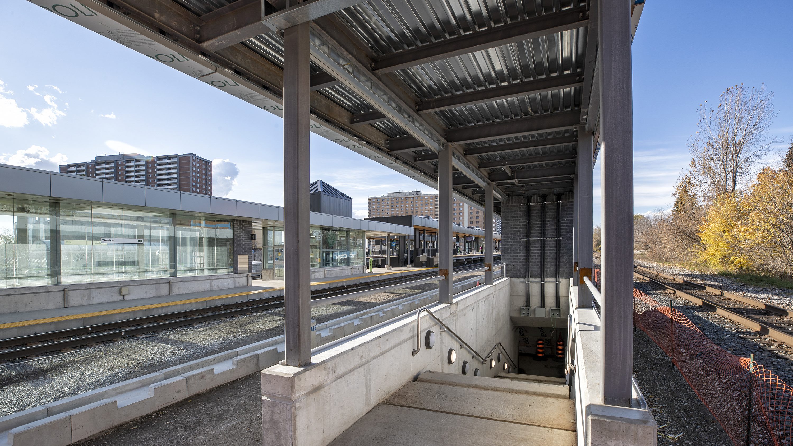 looking down a flight of stairs from a train platform