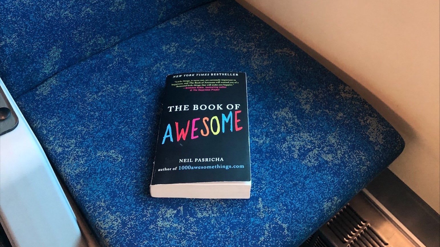 A book sits on a seat.