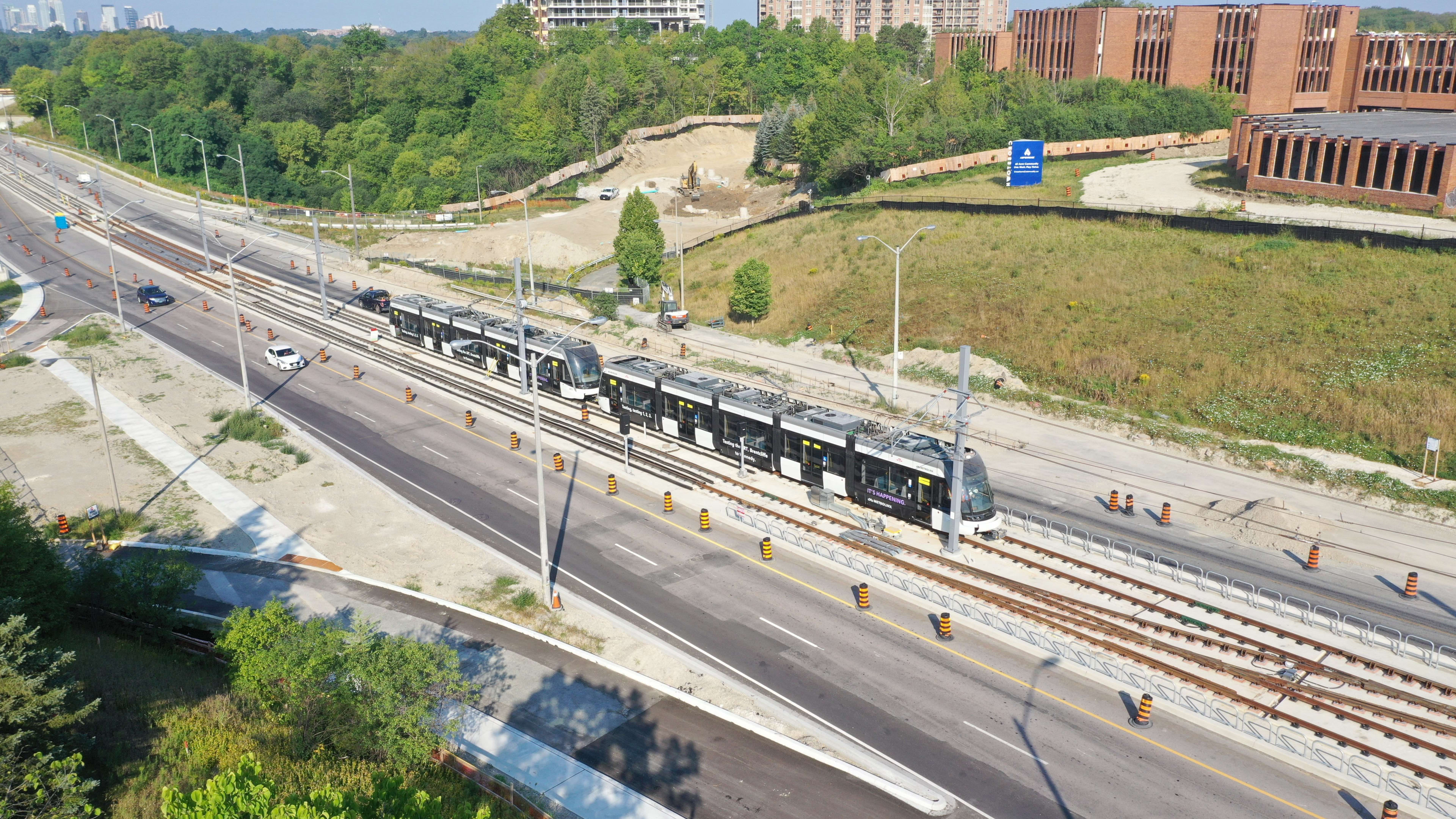 Two Crosstown vehicles head out on one of the first test runs along Eglinton Avenue East.