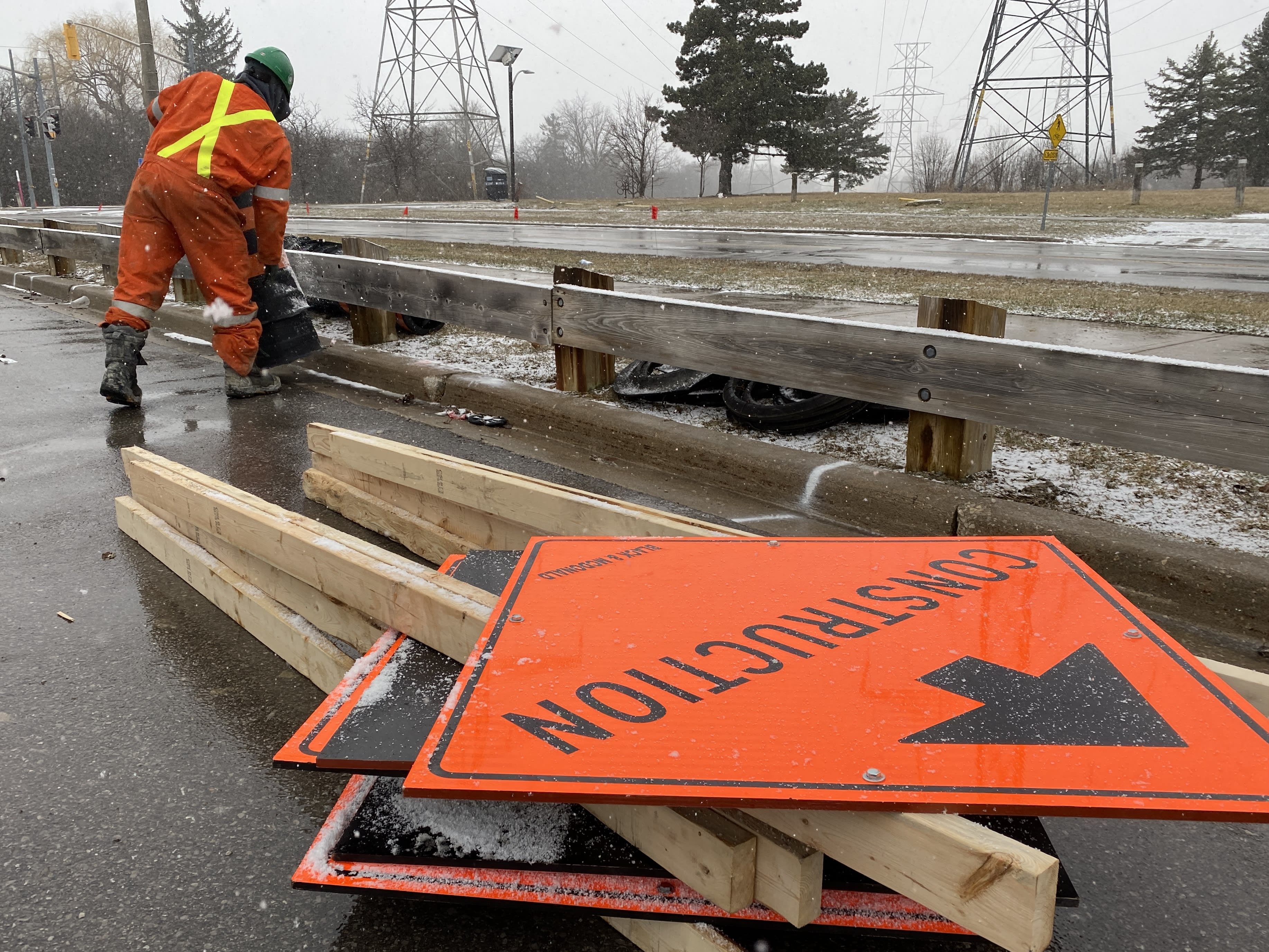 Crews prepare a work site at a commuter parking lot near Finch Station.