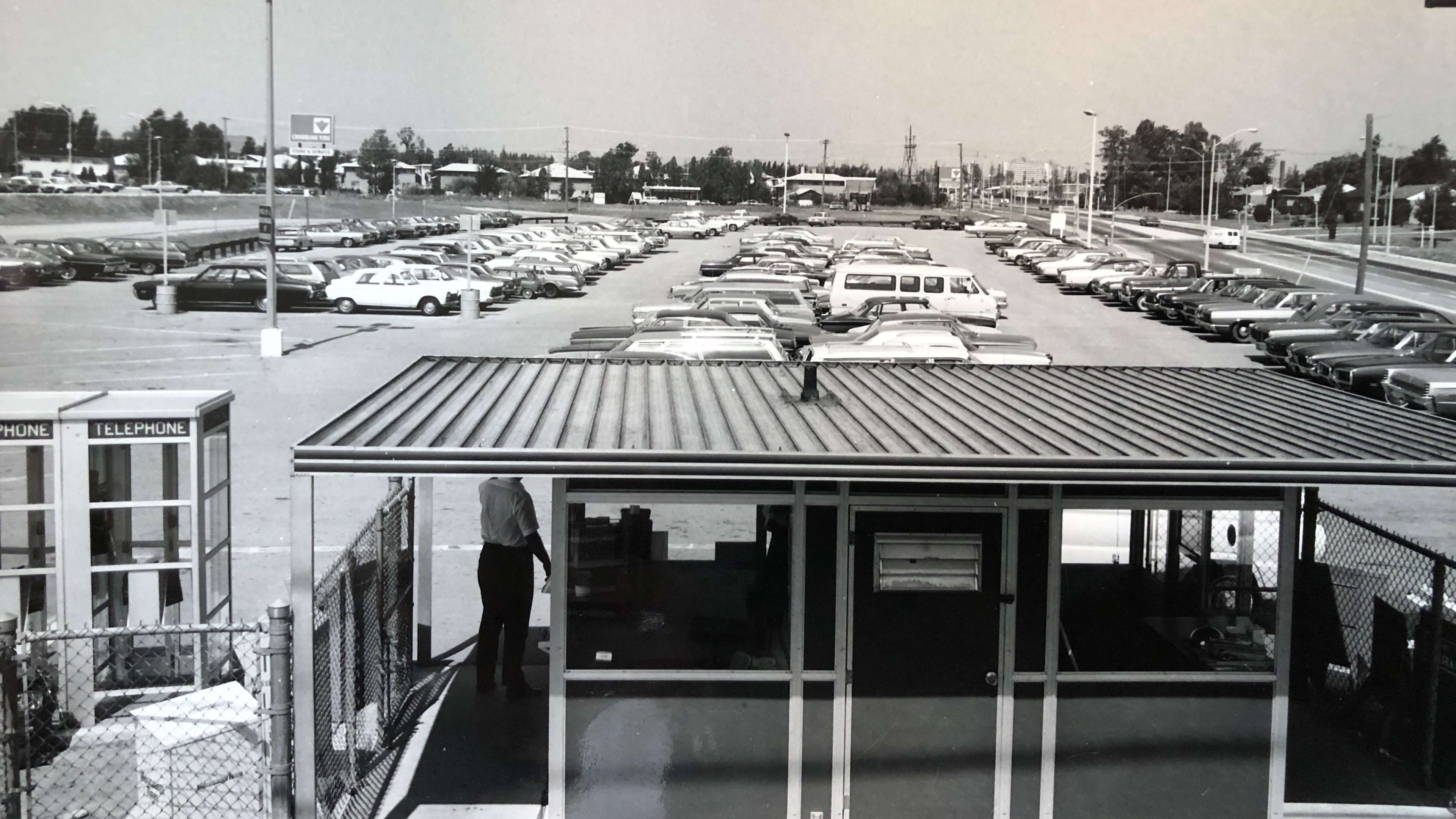 Cars line a GO station parking lot.