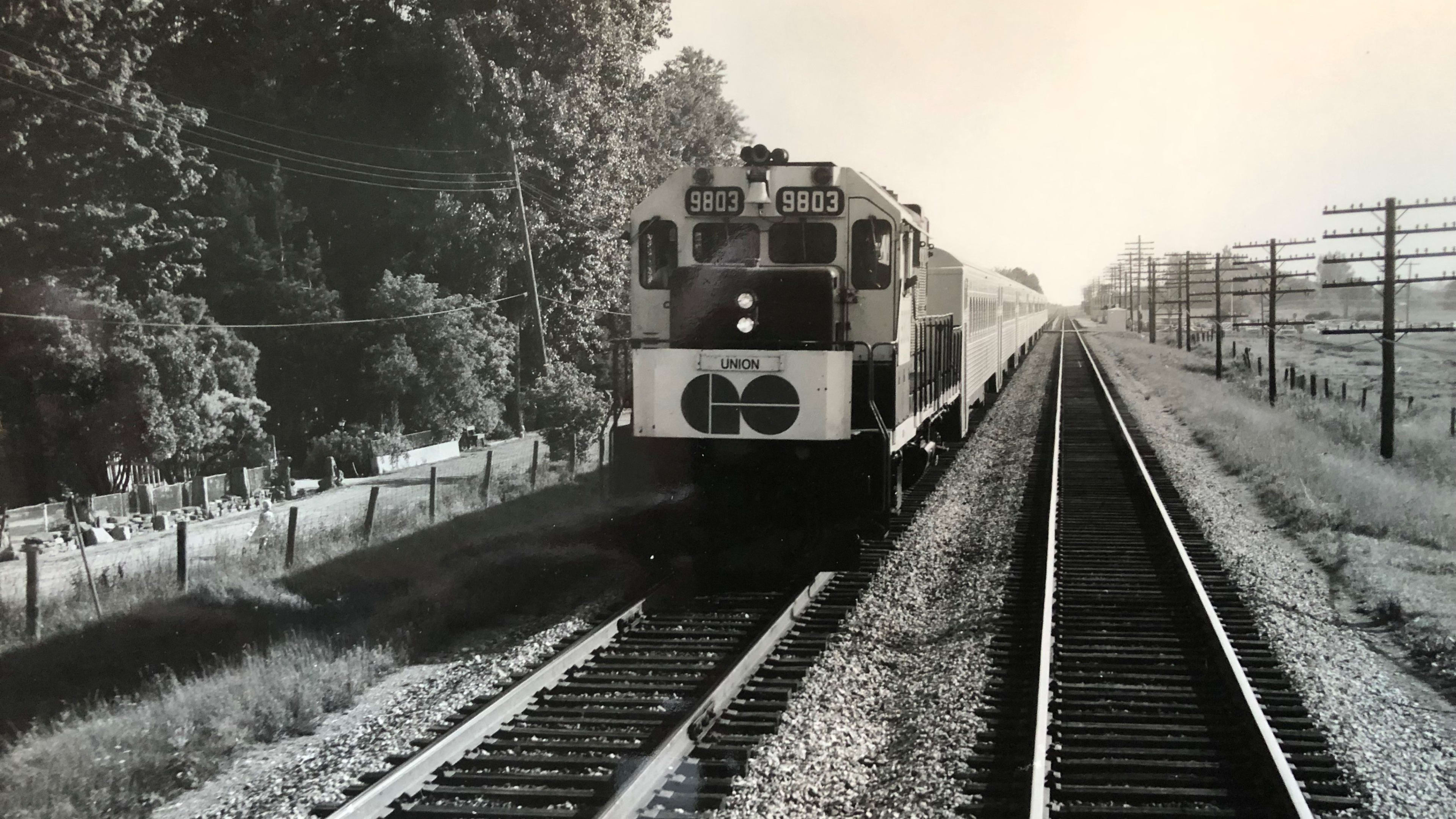 A GO train moves down a line.