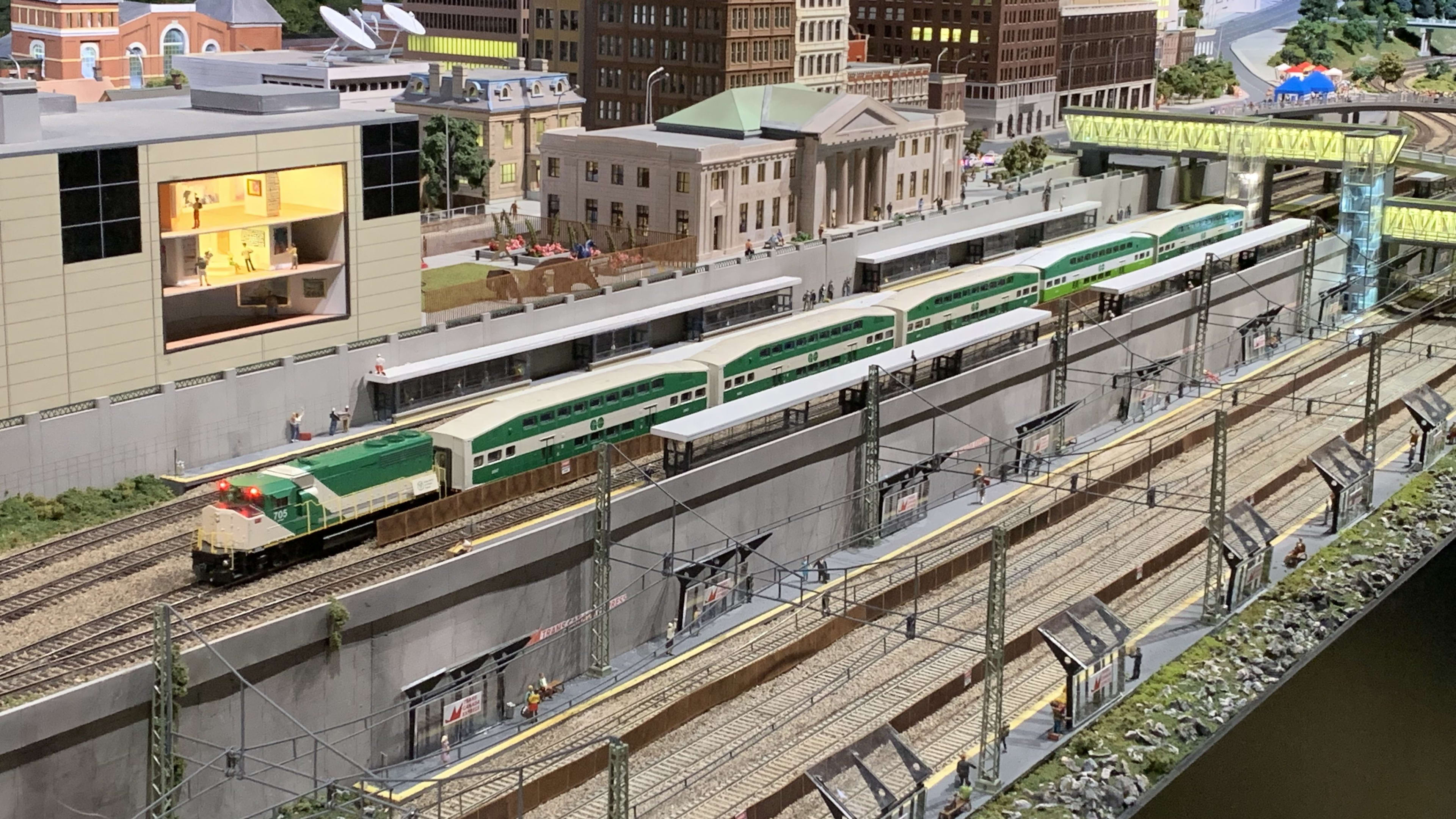 A model GO train sitting idle at a station