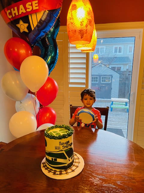 Little boy (Bodhi) with his cake and balloons