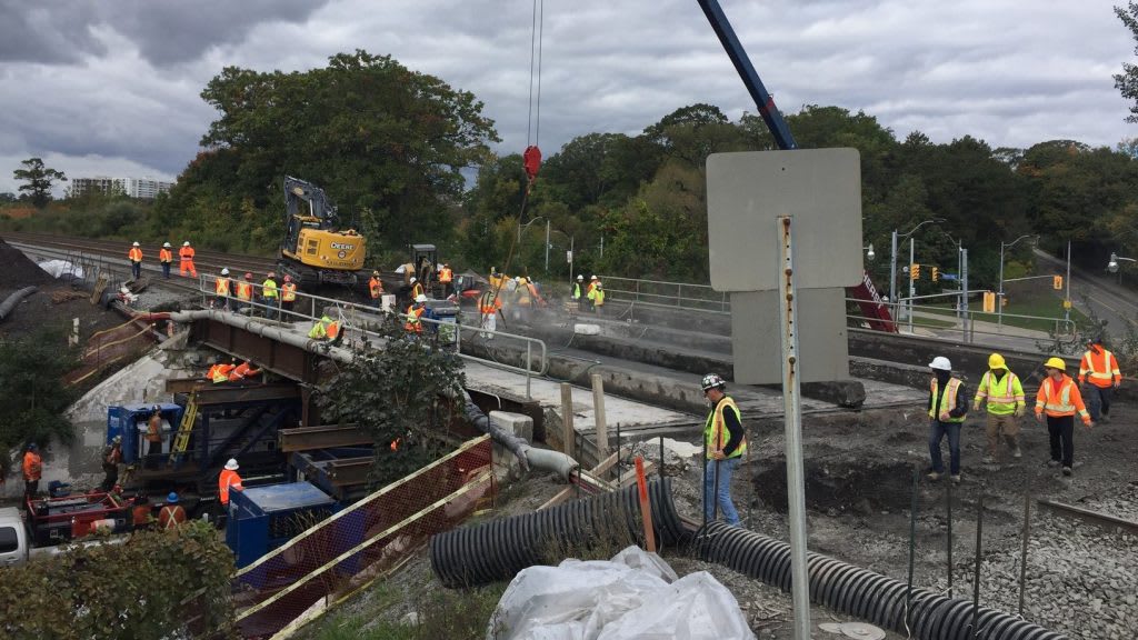 workers replacing a train bridge