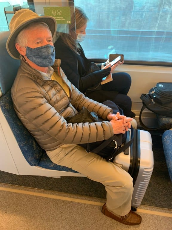 GO customer sits in a seat with a mask