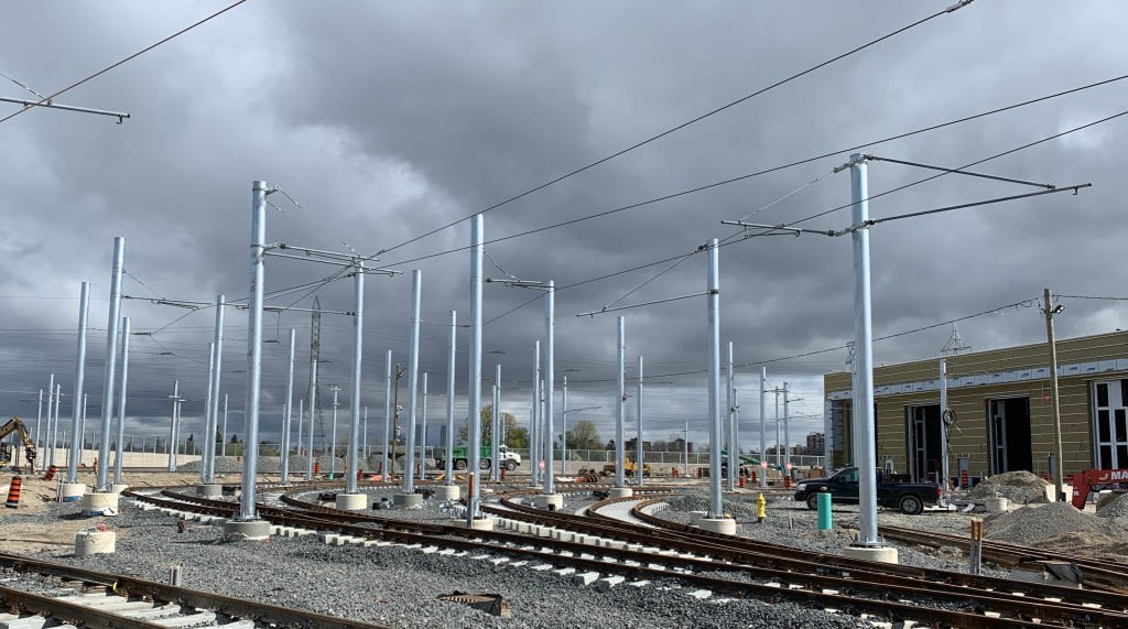 the power lines and poles next to the tracks.