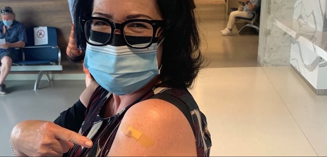 Anne Marie Aikins proudly shows proof of her COVID 'jab'.