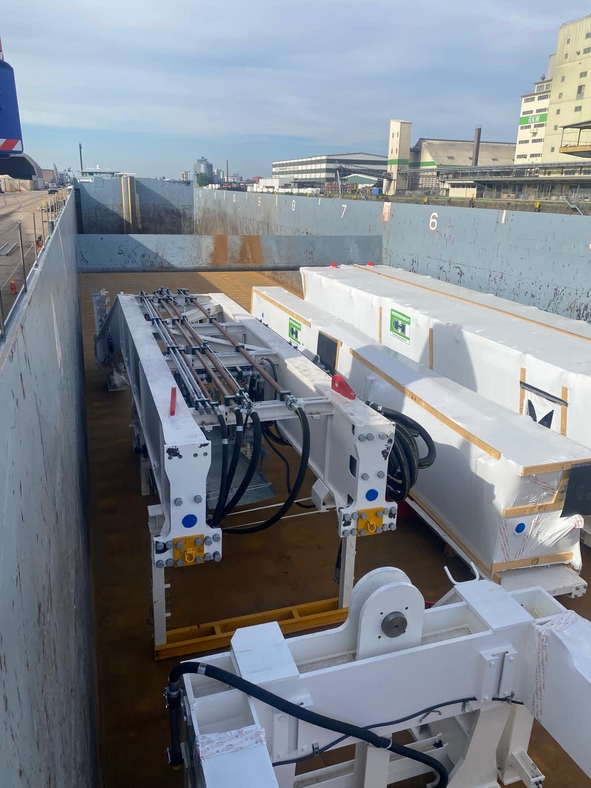 Photos showing pieces of the OL TBMs being loaded onto the boat for transfer
