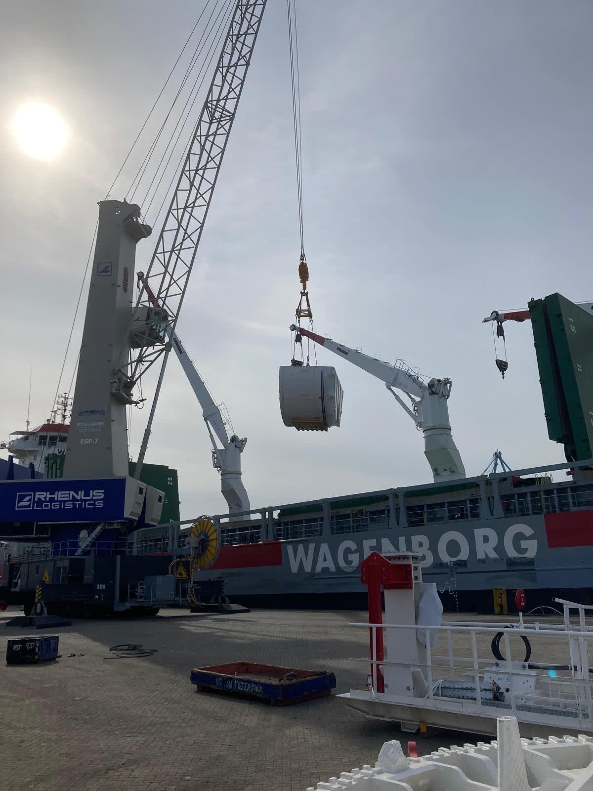 Photos showing pieces of the OL TBMs being loaded onto the boat for transfer