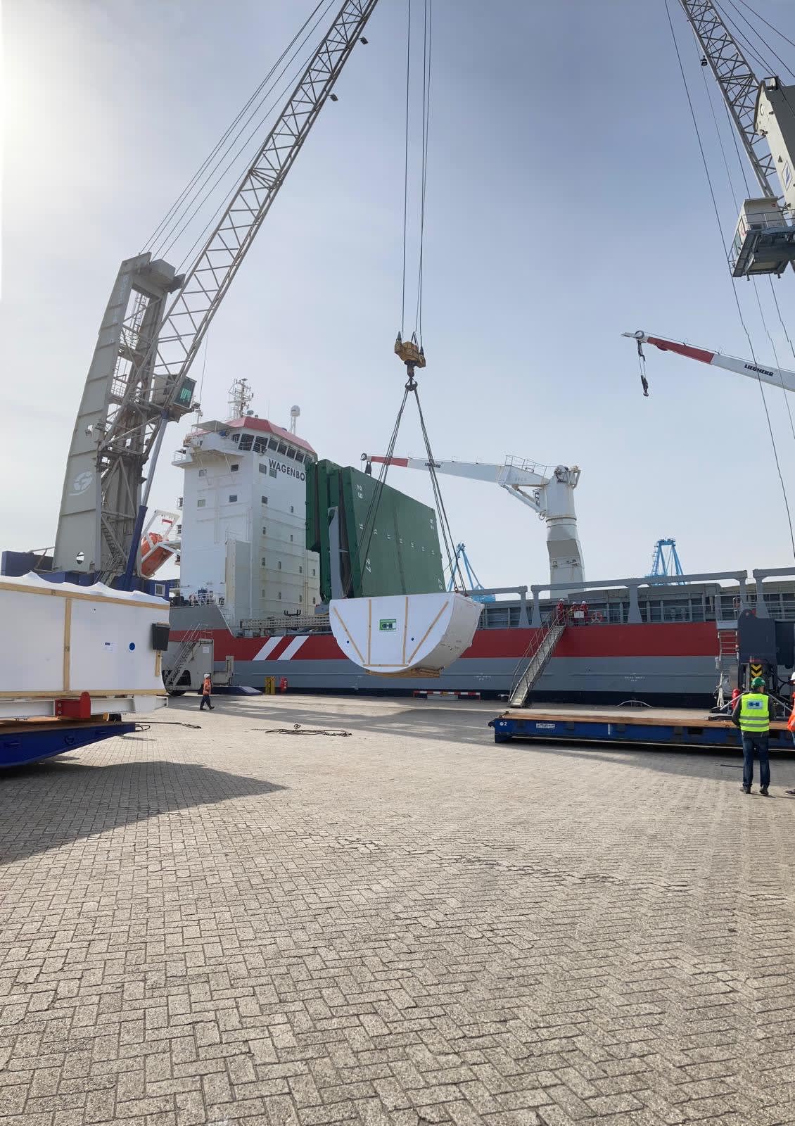 Photos showing pieces of the OL TBMs being loaded onto the boat for transfer