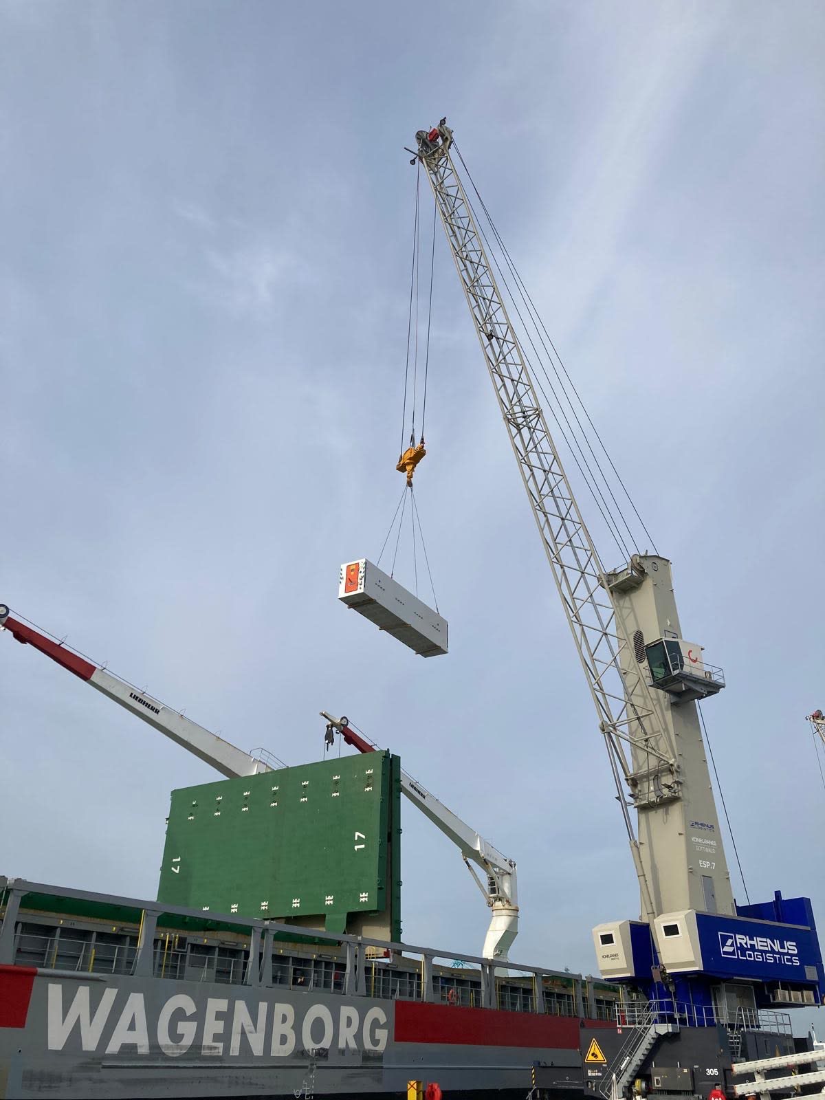Photos showing pieces of the OL TBMs being loaded onto the boat for transfer