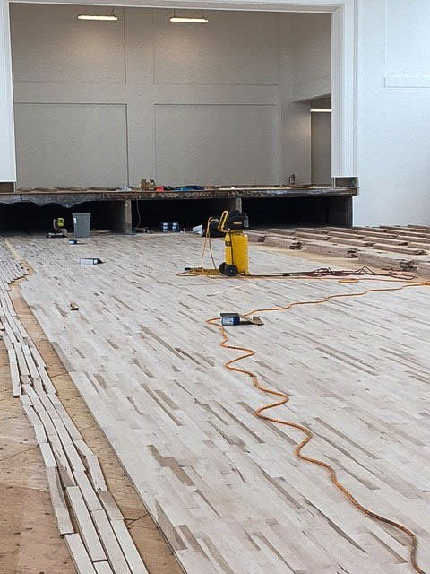 Hardwood floors are prepped inside the building.