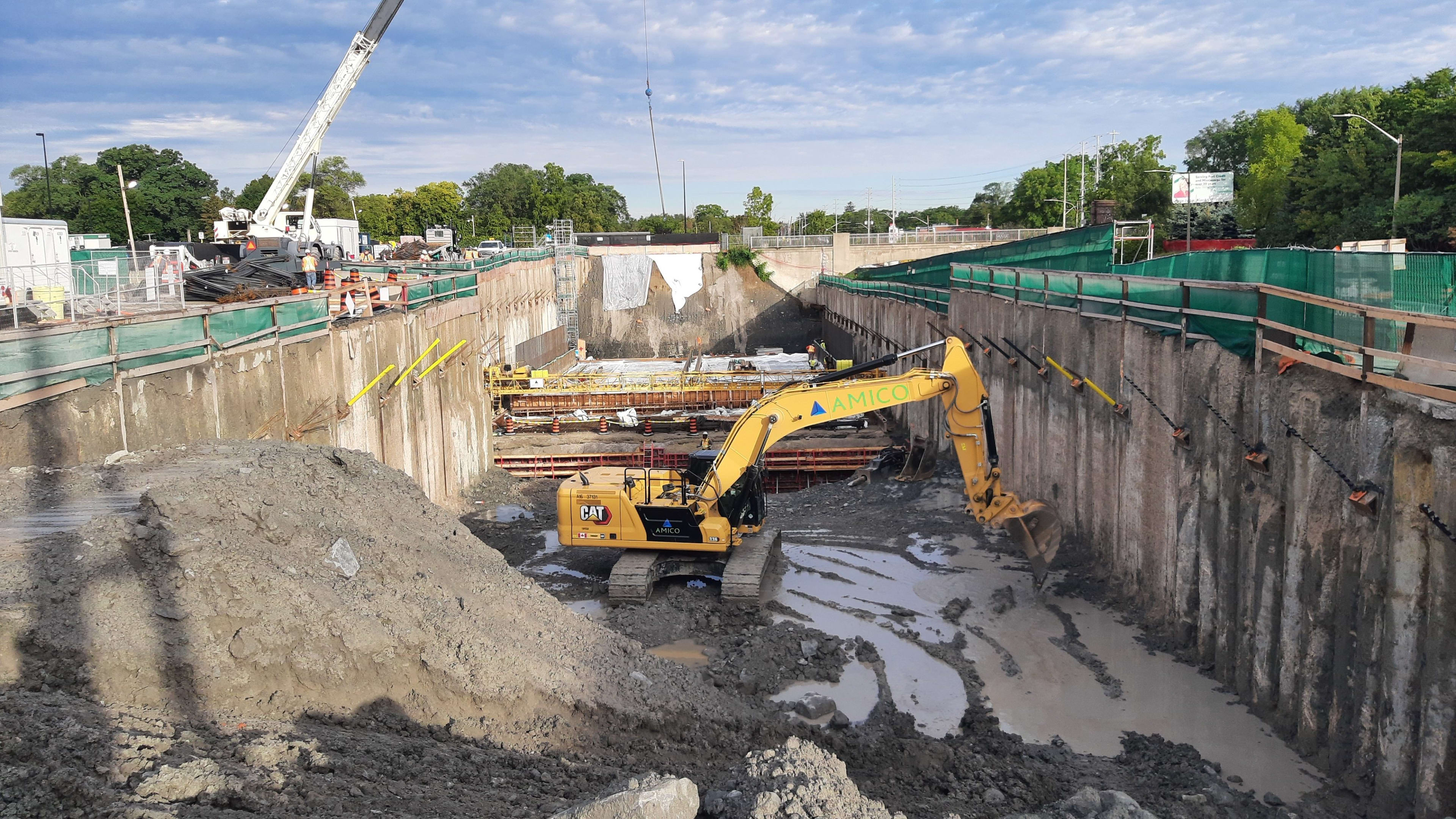 a muddy work site and large machinery.