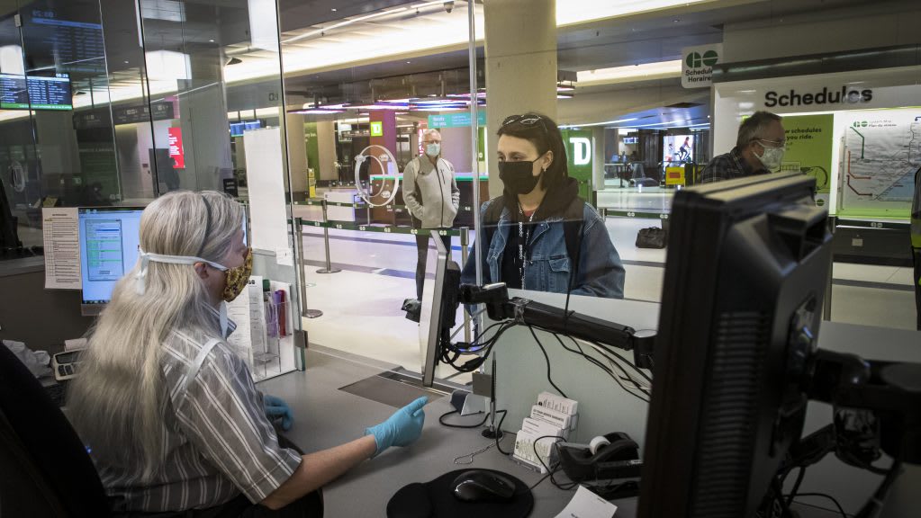 customer service desk, customer and staff with mask on
