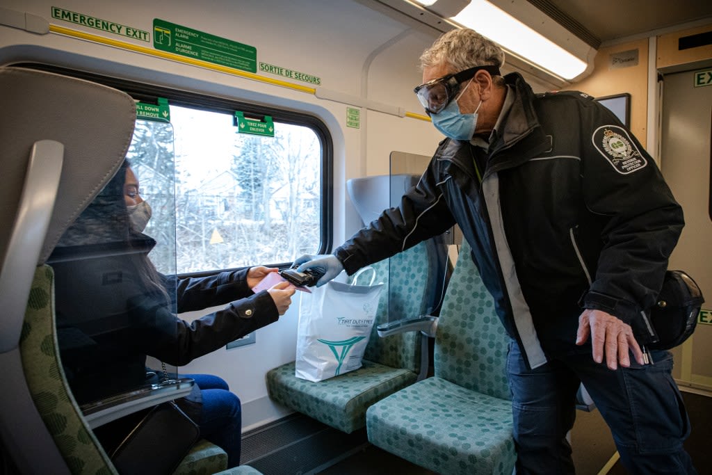 A fare inspector checking a customer's PRESTO card