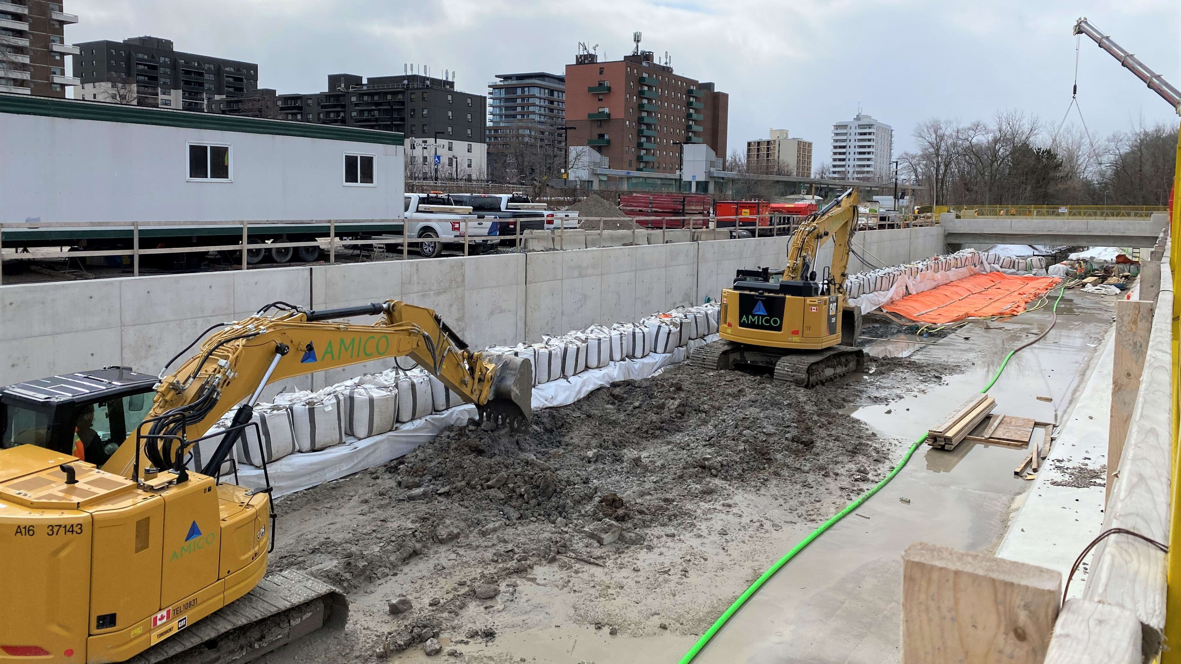 excavators in the creek bed digging