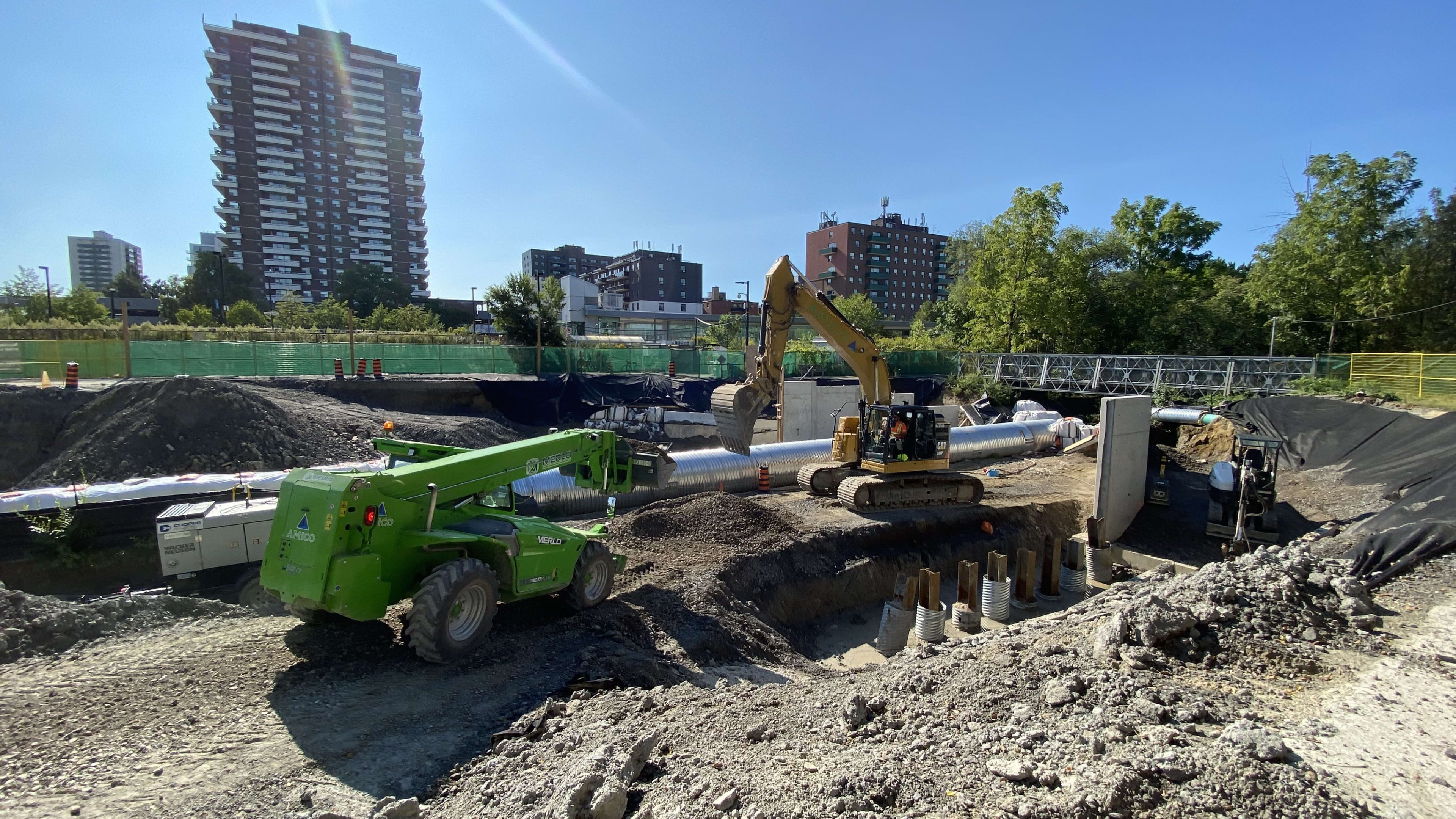 Crews move dirt at a site.