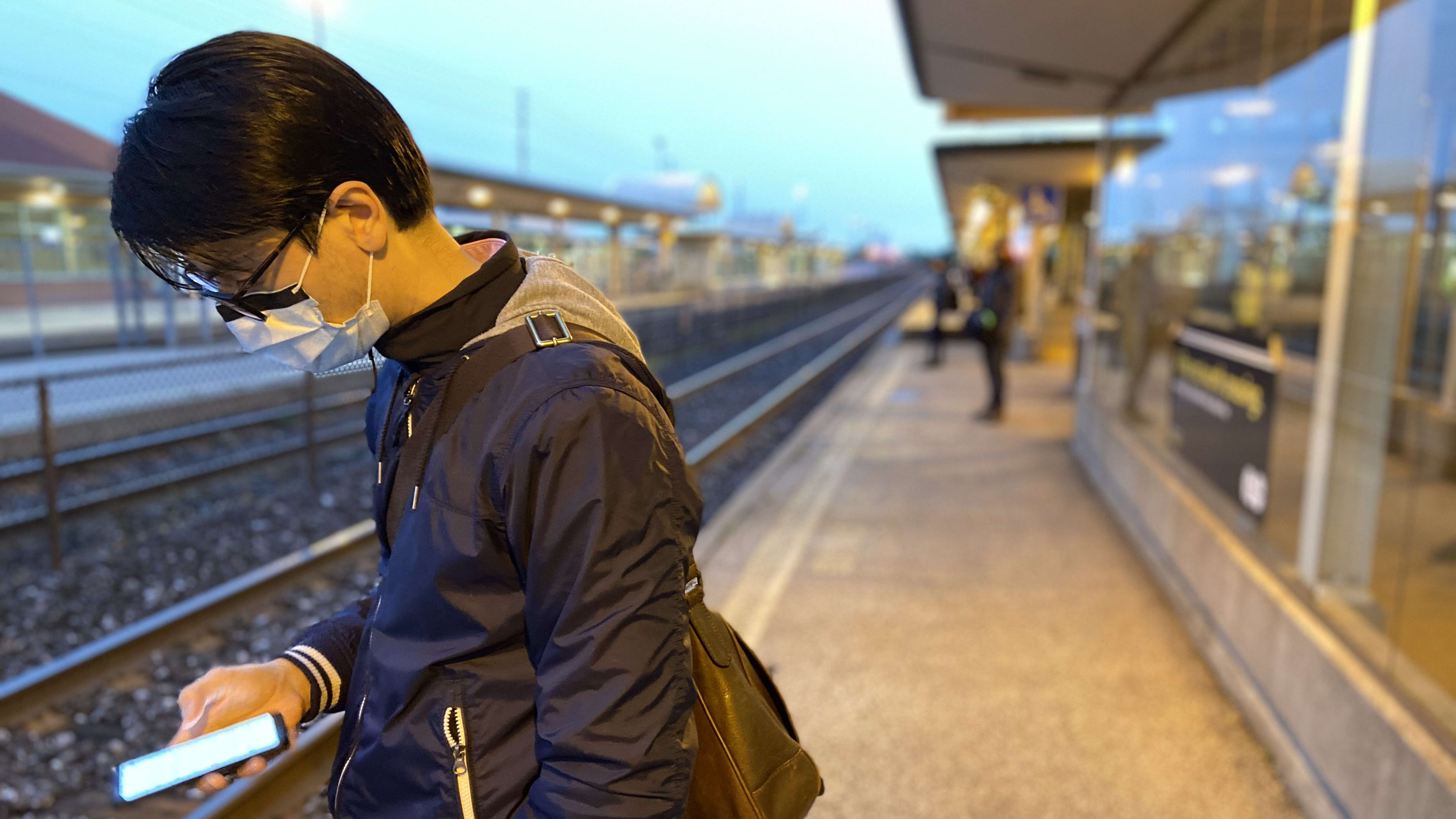 GO customer stands on a platform with a mask on