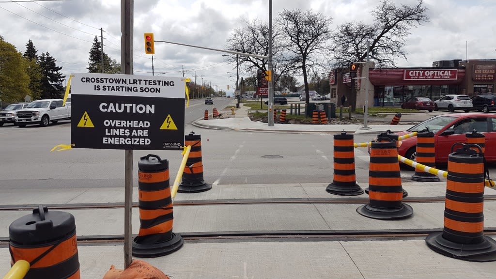 Construction cones and a construction safety sign along Eglinton