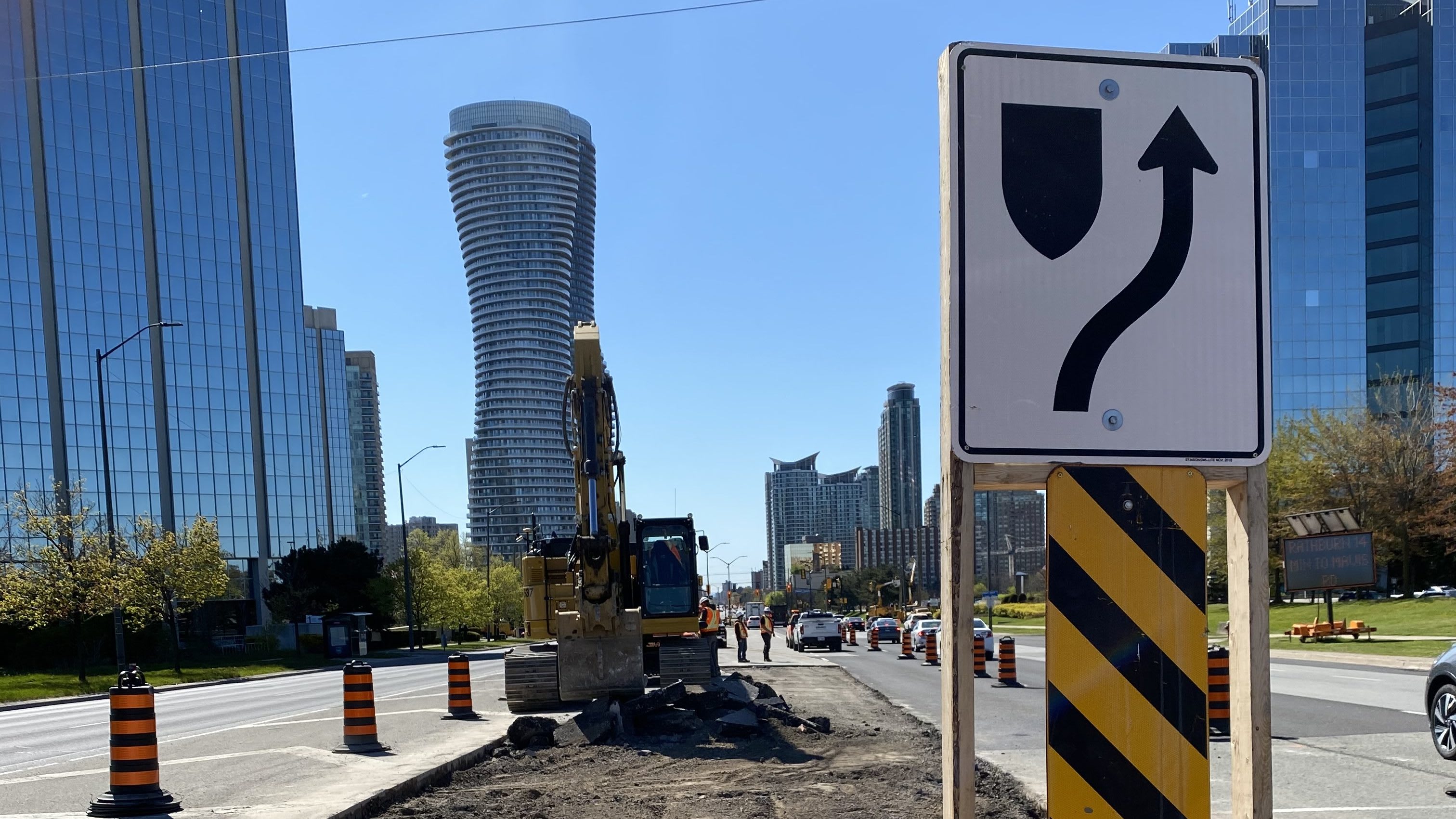 An excavator works along Hurontario street to remove the concrete medians that run along the midd...