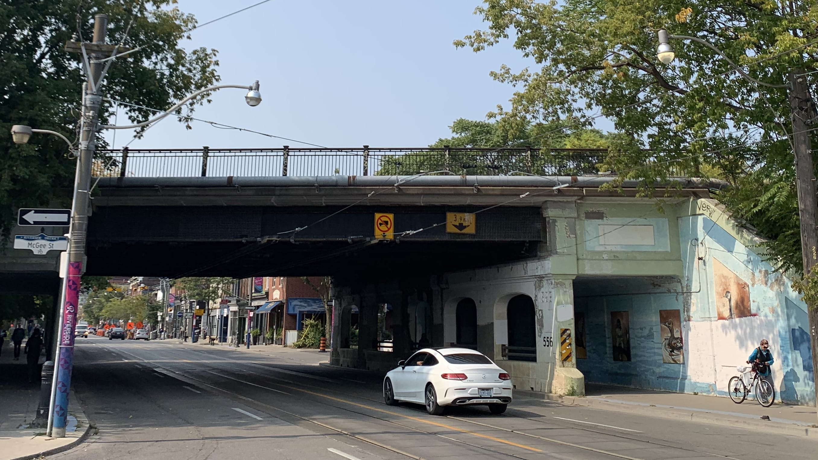 Looking west on Queen Street East towards the aging rail bridge