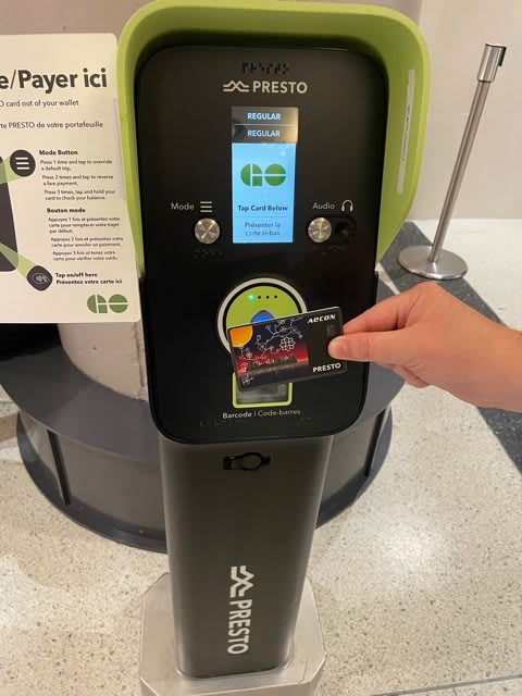Image of a PRESTO card being used ot a machine.