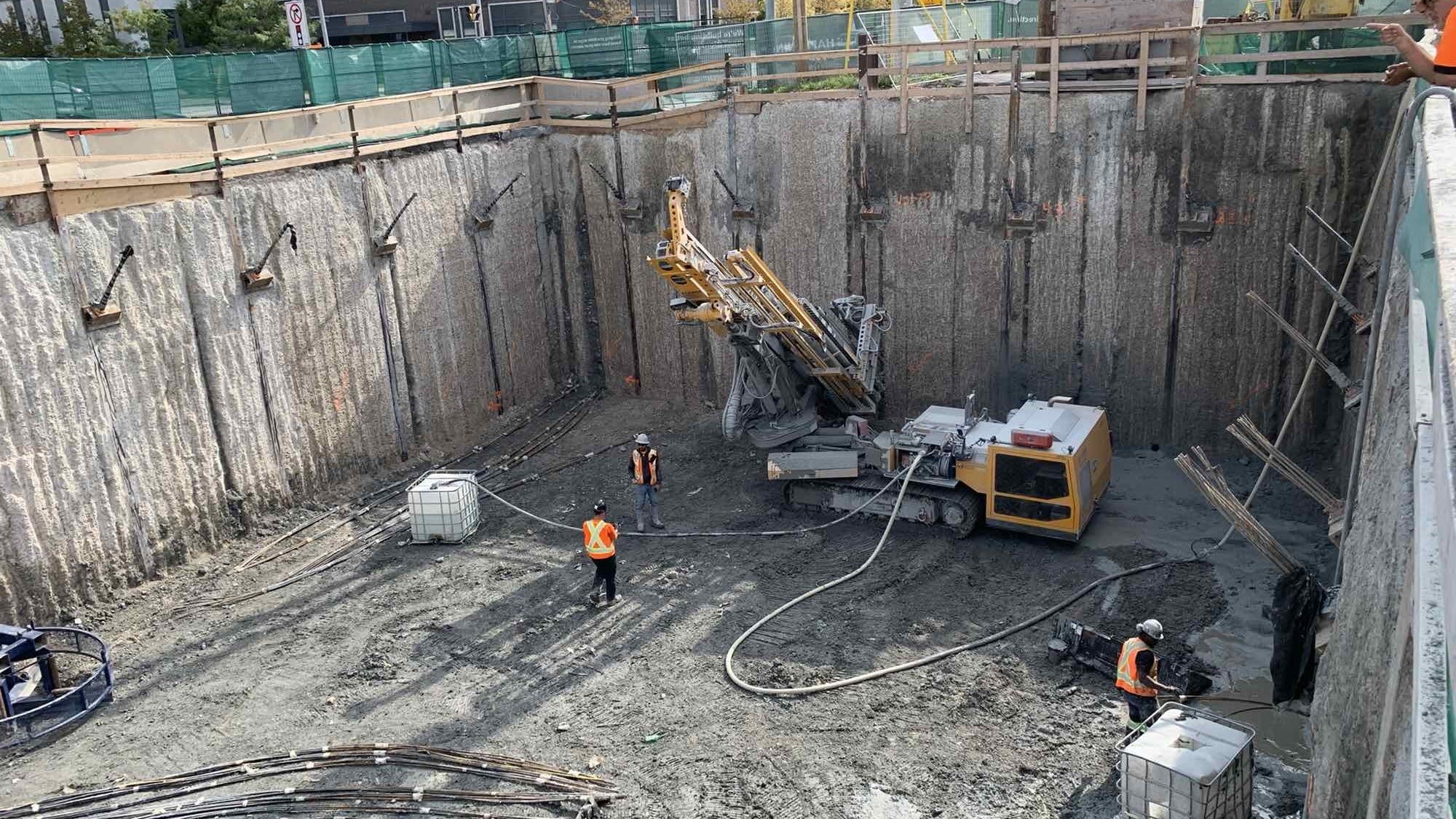 Crews work in a pit.