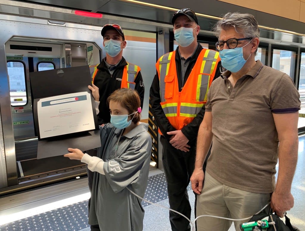 Romina and her father stand next to Alstom engineer Tony Borek and Alstom conductor Aaron Trude