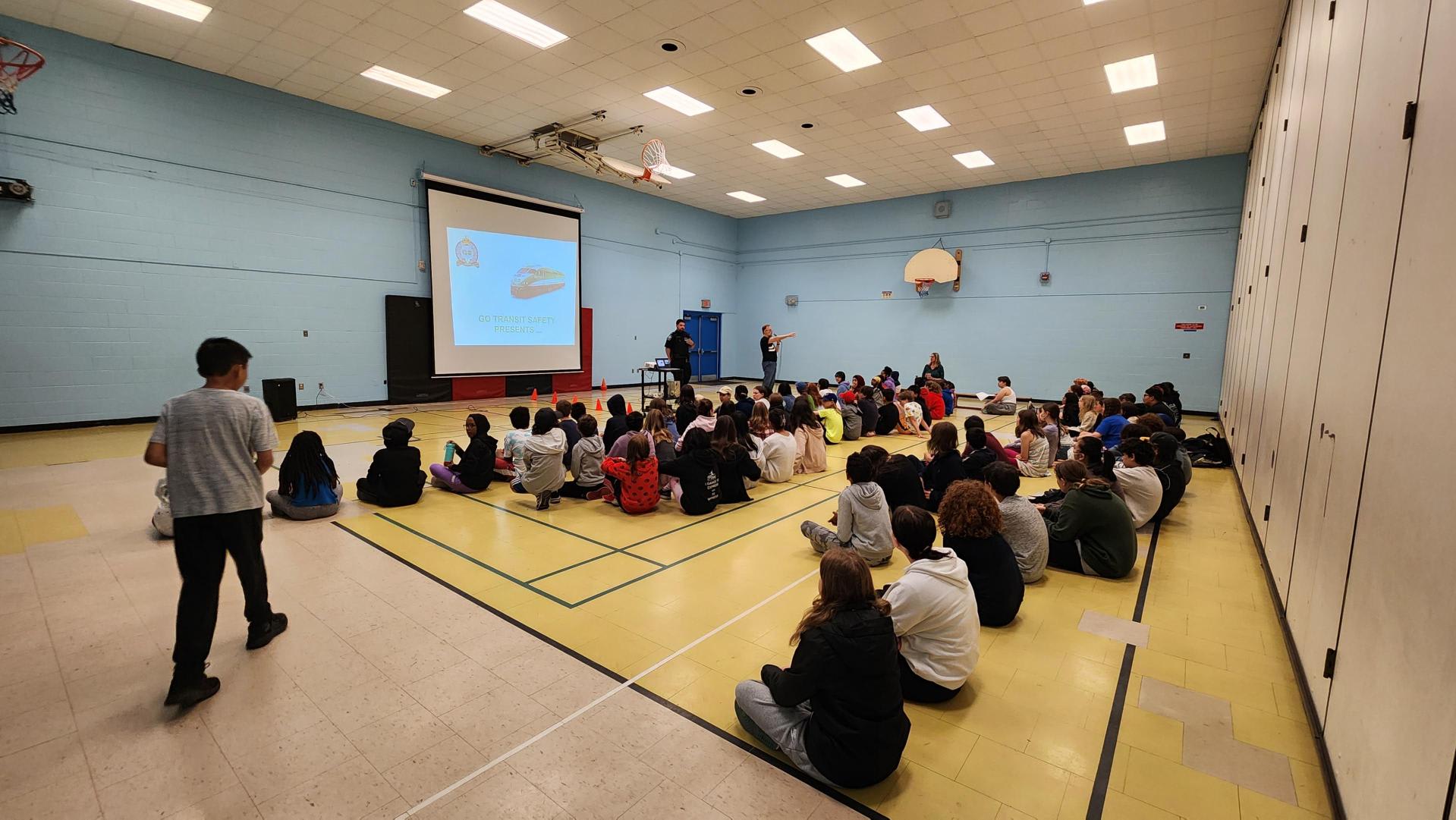 Children receive a safety presentation from Metrolinx