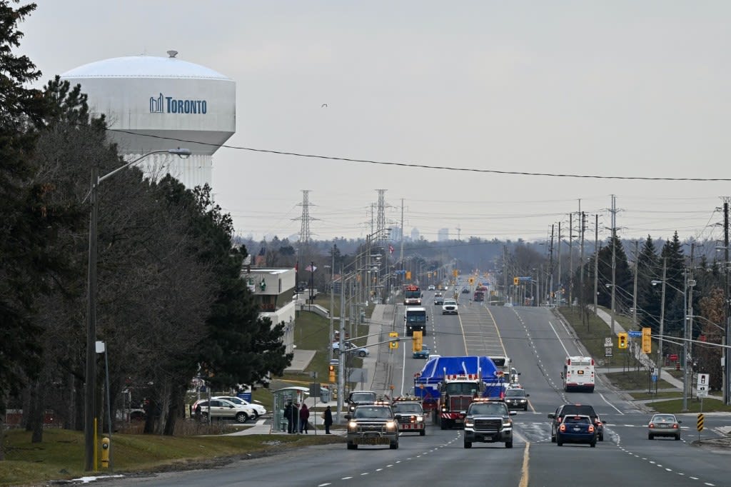 a truck coming down a road with the TBM on the back.