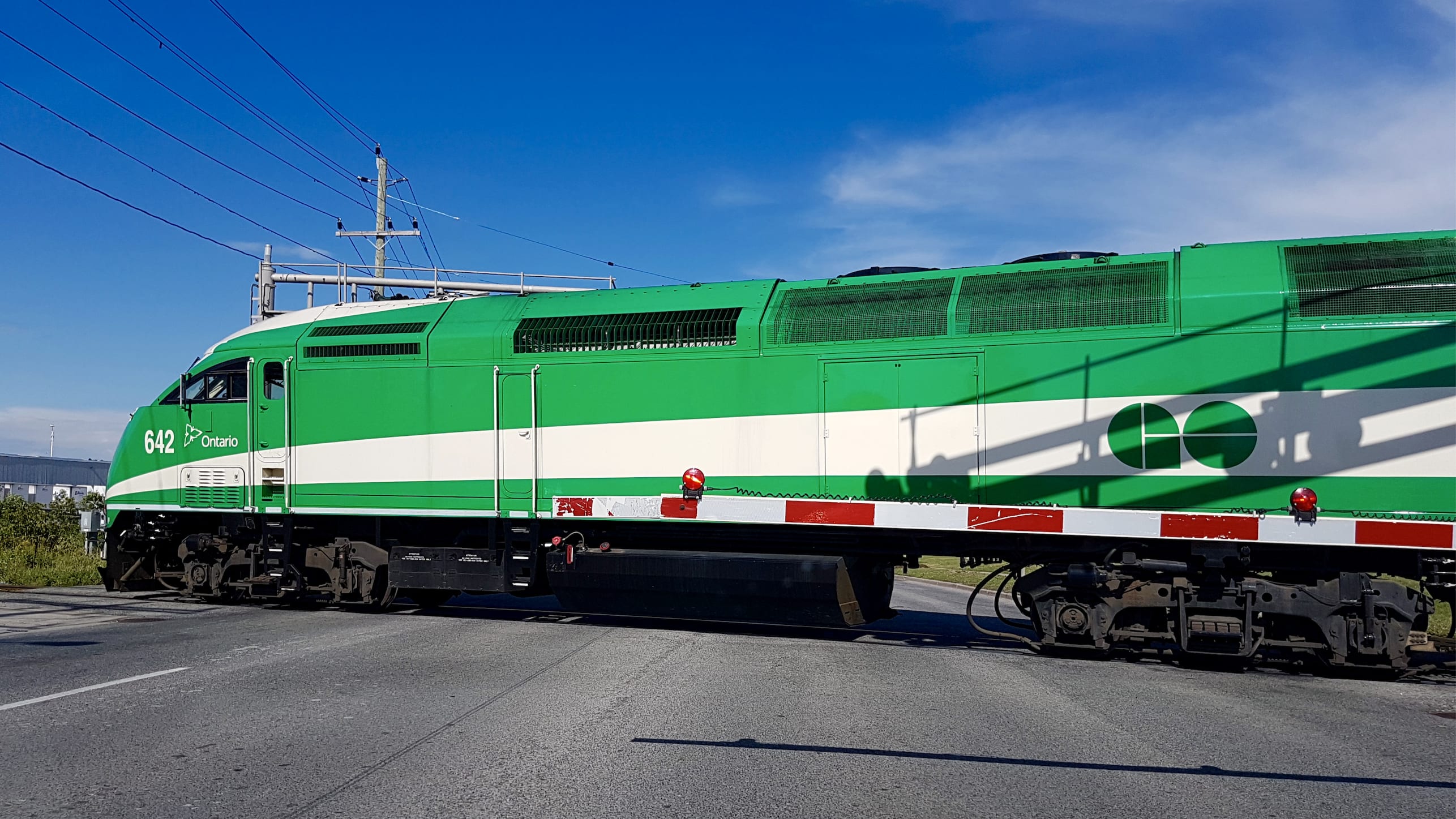 GO train passes through a level crossing