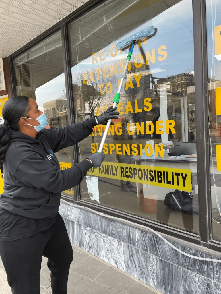 A woman washing a window