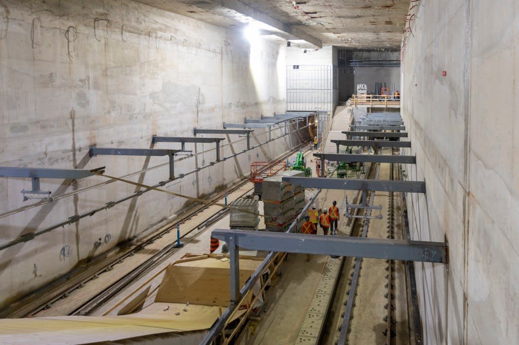 Crewmembers walk along a platform