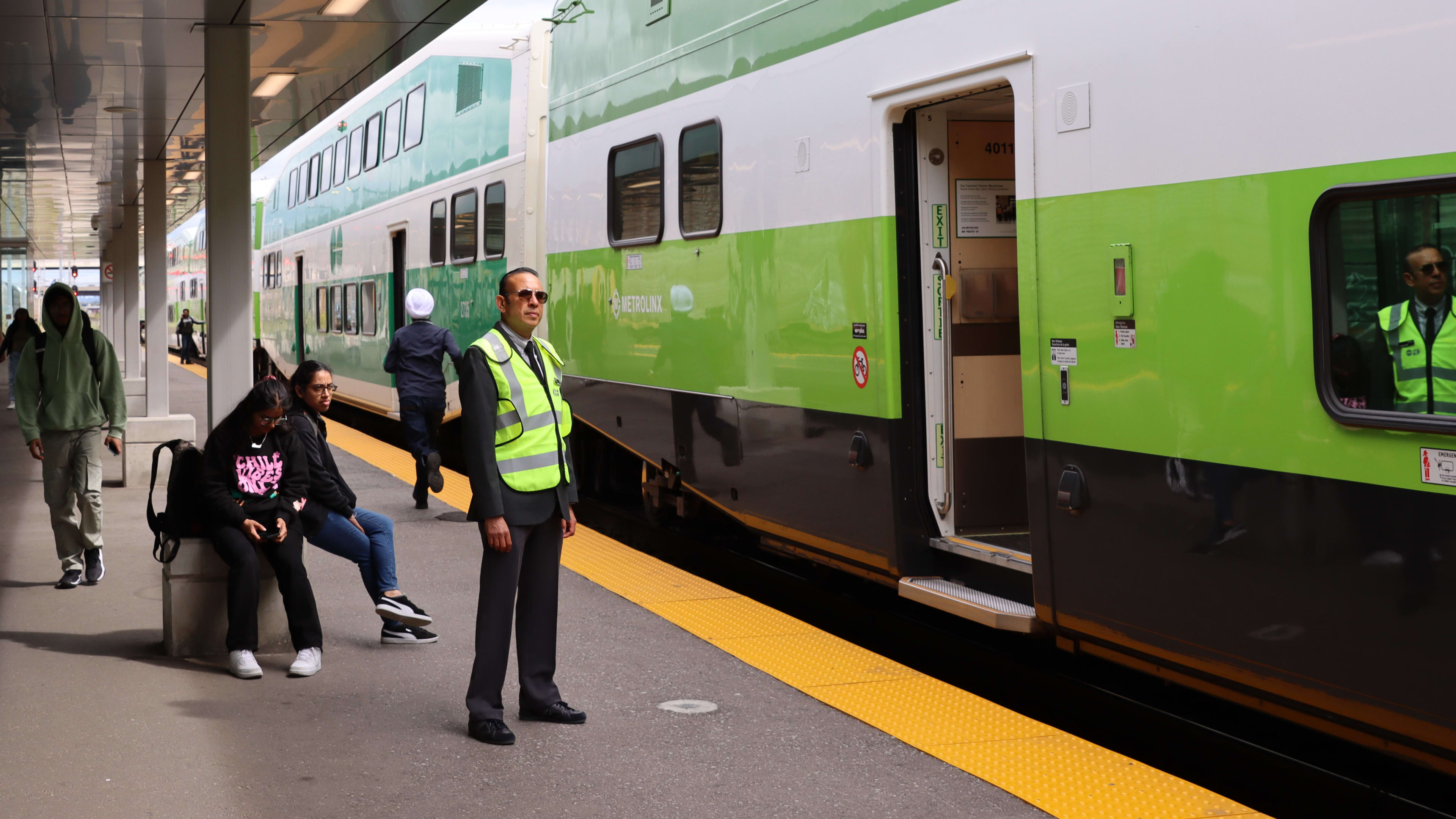 Shahnawa Rasul, a station ambassador, stands at Bramalea GO as a train prepares to depart