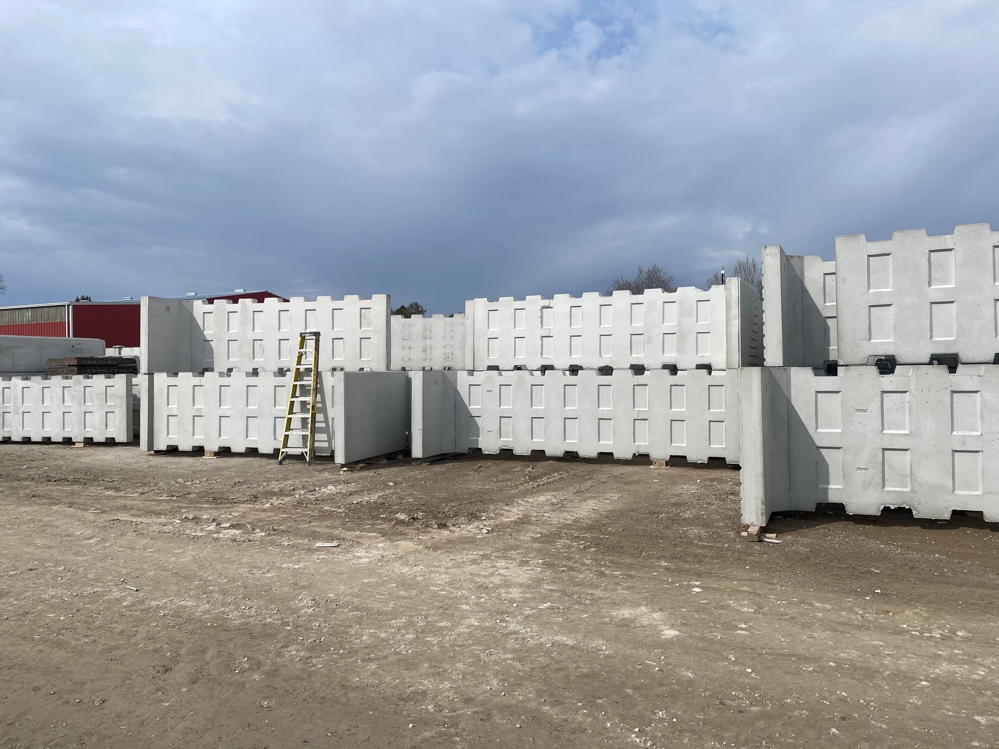 Image of a stockpile of t-walls for new Ontario Line retaining walls