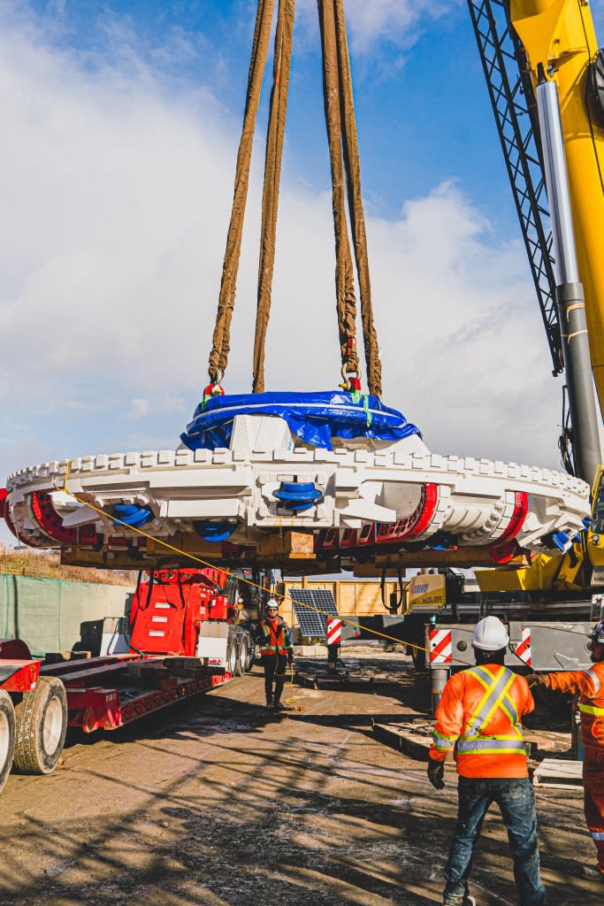 a crane raising the big TBM.