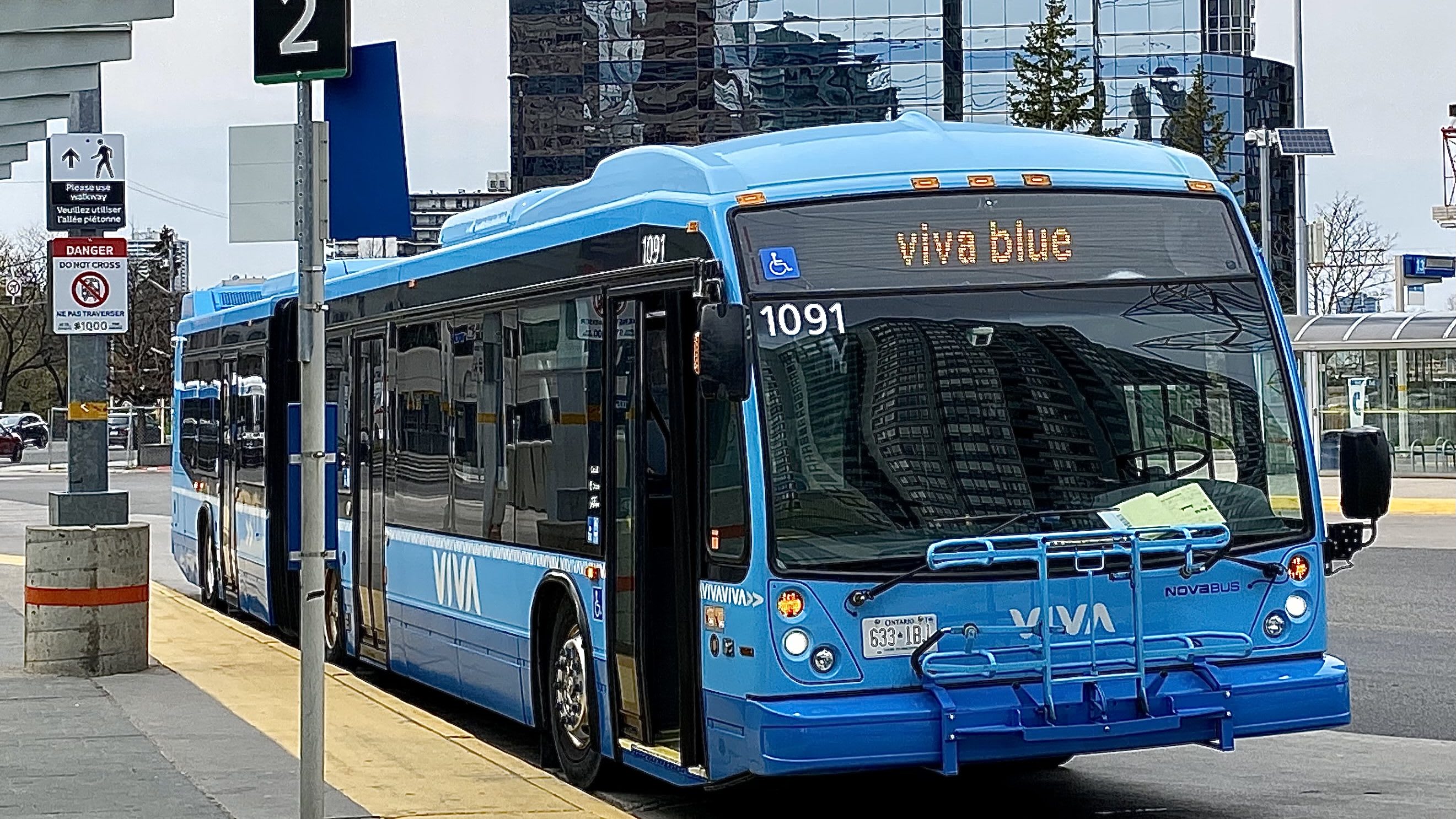 A Viva Blue bus arrives at a stop.