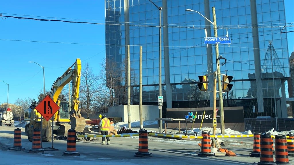 Photo shows a tractor at an intersection.